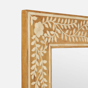 Close-up of the Adelise Oak & Bone Mirror by Made Goods, featuring a white oak frame with an ivory bone floral and vine inlay on a light brown background.