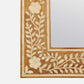 Close-up of the Adelise Oak & Bone Mirror by Made Goods, showcasing inlaid floral and leaf patterns in light material on its frame.
