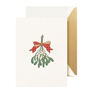 The Crane Mistletoe Bough Box Set includes greeting cards with mistletoe tied by a red ribbon, paired with gold-lined envelopes for a festive touch.