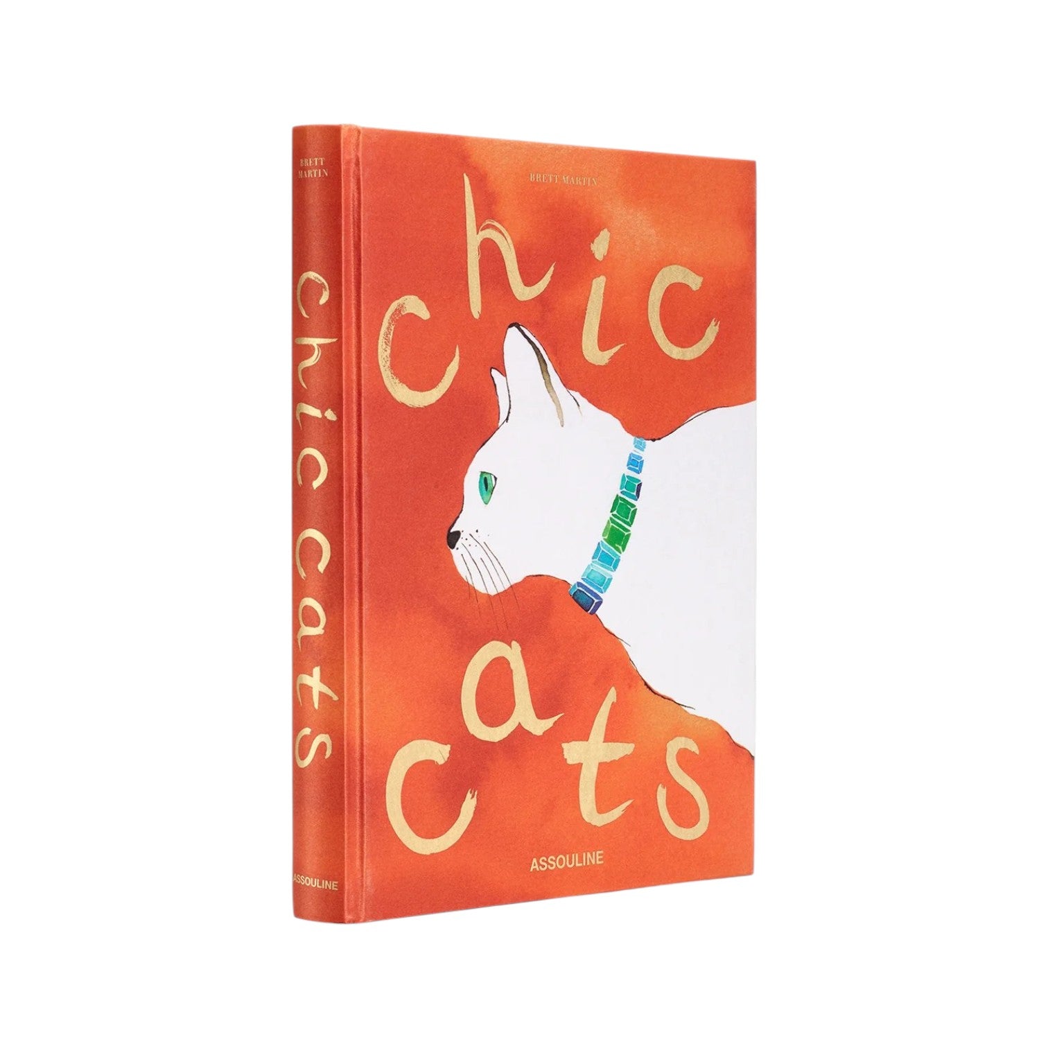 Assouline’s "Chic Cats" is a hardcover book featuring a white cat with a green collar on an orange cover, celebrating cat-inspired artwork and feline art.