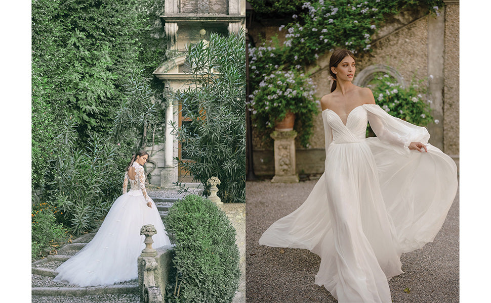 Two women in elegant bridal gowns pose outdoors; one stands on stone steps near lush greenery, while the other lifts her flowing gown from the Monique Lhuillier collection by Penguin Random House as she walks on gravel beside a stone wall adorned with plants.