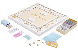 A Monopoly Bianco Edition setup, featuring die-cast tokens, paper money, cards, dice, and property deeds arranged around the premium game board by WS Game Company.