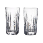 Two clear Montpelier Highball glasses from the Simon Pearce Montpelier Highball Gift Set, featuring vertical cut patterns, are placed side by side on a white background to showcase their elegant design.