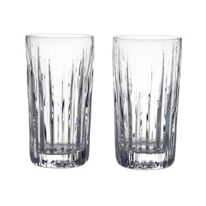Two clear Montpelier Highball glasses from the Simon Pearce Montpelier Highball Gift Set, featuring vertical cut patterns, are placed side by side on a white background to showcase their elegant design.