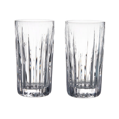 Two clear Montpelier Highball glasses from the Simon Pearce Montpelier Highball Gift Set, featuring vertical cut patterns, are placed side by side on a white background to showcase their elegant design.
