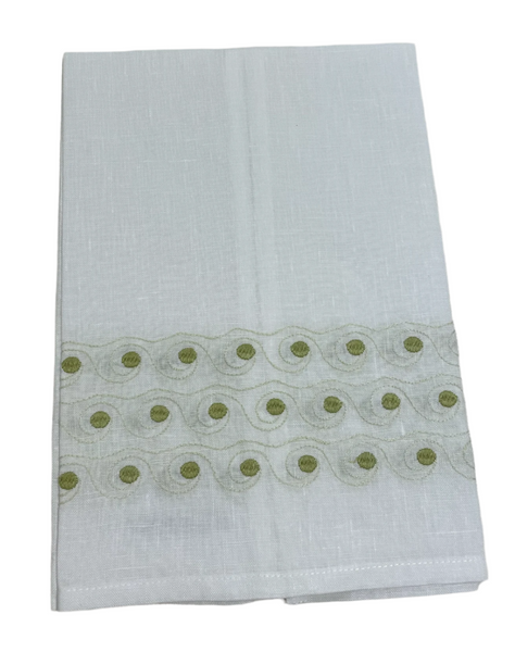 The Haute Home Breaker Wave Tip Towel features a white Italian linen design with an elegant green hand-embroidered pattern.