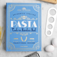 The PrintWorks Pasta Tool Set is displayed on a white surface with pasta, a grater, two eggs, and a blue "Pasta" cookbook—everything you need for memorable Pasta Nights.