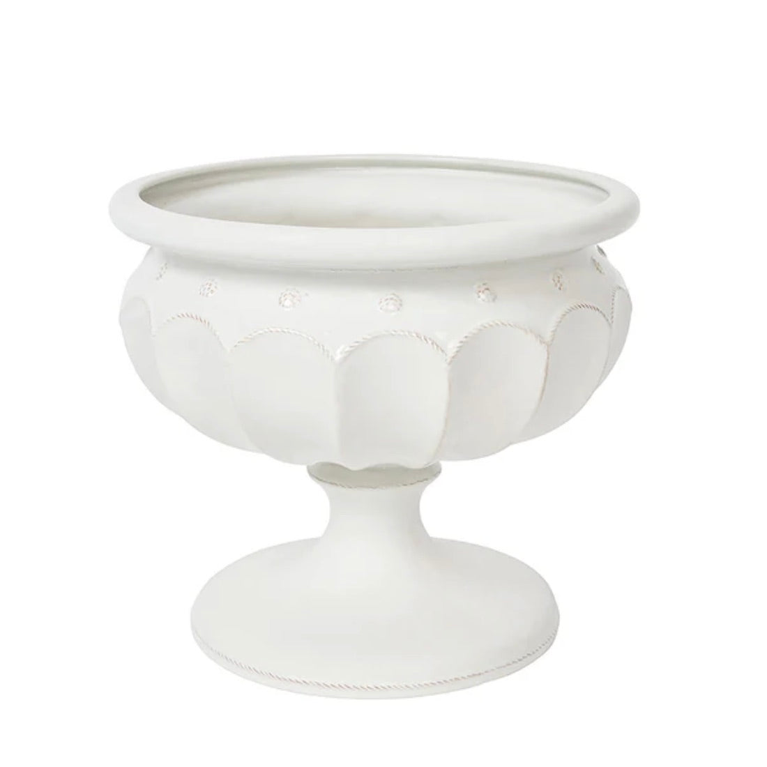 The Juliska Large Whitewashed Decorative Urn features a pedestal design with scalloped patterns and circular accents, making it an elegant centerpiece or a stylish addition to your formal garden décor.