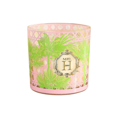 The Mrs. H Candle by Slatkin & Co. features pink and green palm leaf patterns, a gold rim, and a central "MRS. H" label—an elegant holder perfect for displaying your favorite bamboo-scented candle.