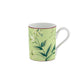 This ceramic mug from the Florenza Impero Dinnerware Collection by Ginori 1735 features a light green background, floral design, white handle, and a slim red rim near the top.