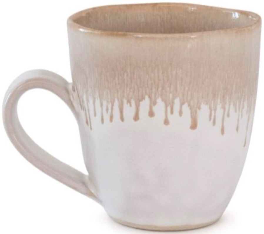 The Burlington Bluff Dinnerware Collection by Simon Pearce features a ceramic mug with a round handle and beige Bluff glaze drip near the rim on a white base, inspired by classic pinch-pot designs.