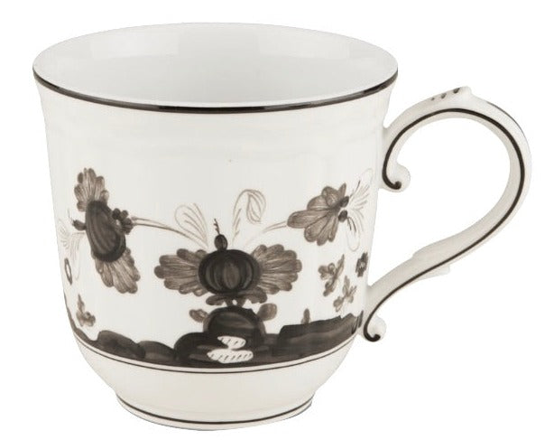 The Ginori 1735 Oriente Italiano Albus Dinnerware Collection features a white ceramic mug with a black Florentine Maison floral pattern and curved handle, inspired by classic designs, shown against a plain white background.