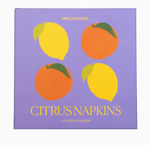 Square purple box from Piecework’s Cocktail Napkin Collection, featuring illustrations of two lemons and two oranges on the lid—perfect for gifting linen cocktail napkins or adding style to your favorite napkin sets.