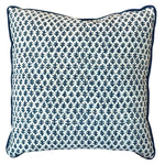The Burma White Indigo Outdoor Pillow by Associated Design features a blue and white small leaf pattern with dark blue piping, shown on a white background—an elegant addition to your pillow arrangement.