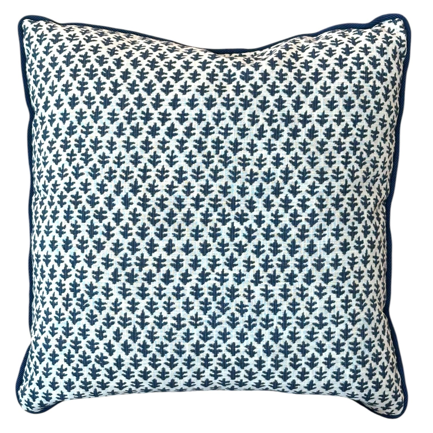 The Burma White Indigo Outdoor Pillow by Associated Design features a blue and white small leaf pattern with dark blue piping, shown on a white background—an elegant addition to your pillow arrangement.
