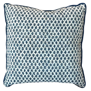 The Burma White Indigo Outdoor Pillow by Associated Design features a blue and white small leaf pattern with dark blue piping, shown on a white background—an elegant addition to your pillow arrangement.