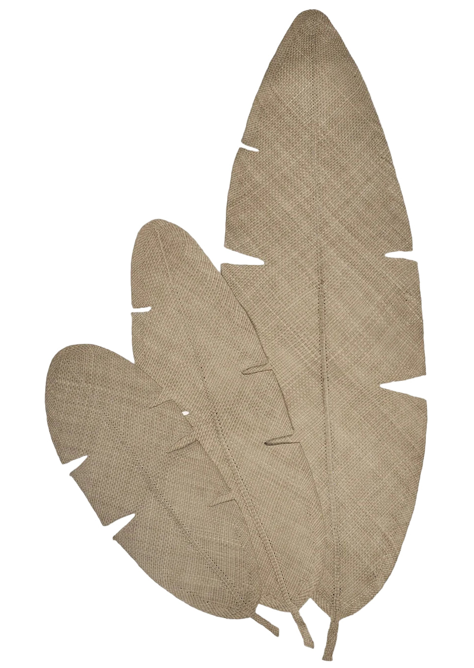 The Mythic Ecosystem Table Mat Collection by Johanna Ortiz features three overlapping, textured beige leaf-shaped mats made from Iraca palm, each detailed with visible veins and small edge notches.