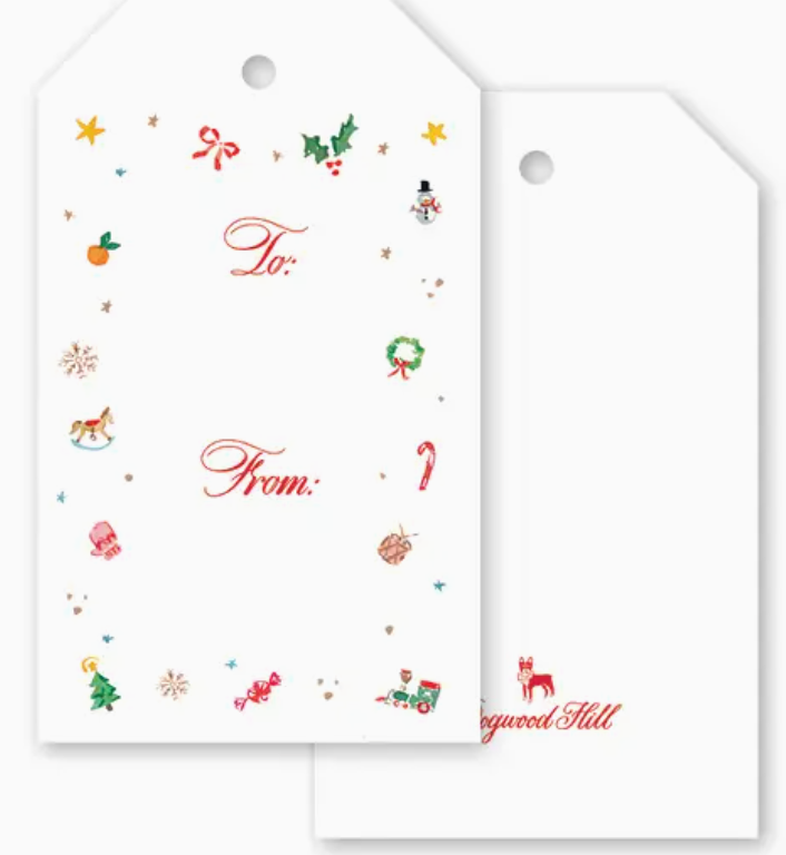 Two white Season’s Trinkets Gift Tag Set tags with a hole at the top, one featuring a border of colorful Christmas-themed icons and the text “To:” and “From:”.