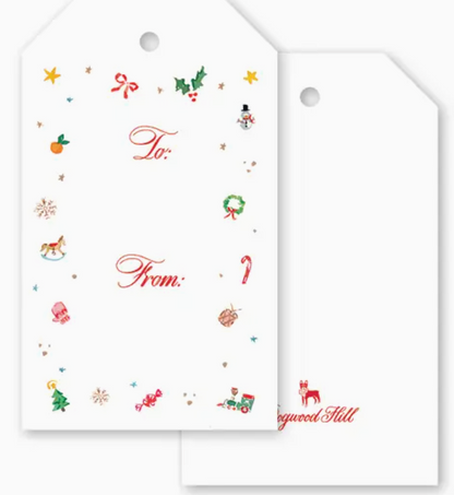 Two white Season’s Trinkets Gift Tag Set tags with a hole at the top, one featuring a border of colorful Christmas-themed icons and the text “To:” and “From:”.
