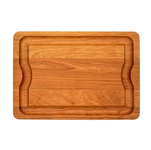 The J.K. Adams Cherry BBQ Board features a recessed juice groove around the edge and two curved side indentations for easy handling.