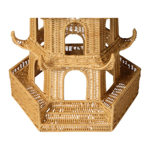 A close-up of the Made Goods Bardot Pagoda in Light Honey Rattan, Large, showcases its woven structure with arched openings and a curved roof inspired by rolling hills.
