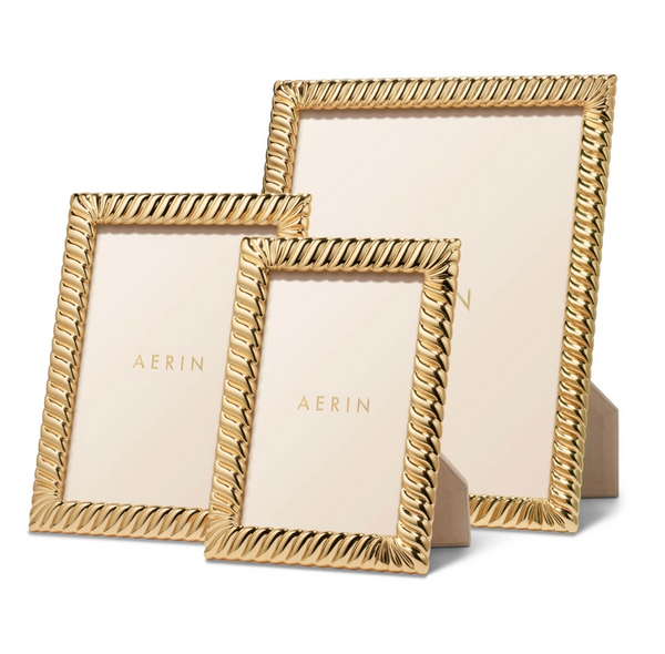 Three AERIN Loretta Frames with a gold twist design by Aerin are on display, each varying in size but sharing a similar look and beige backing.