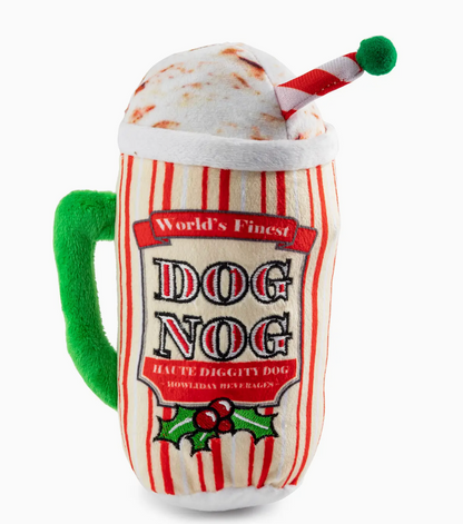 The Haute Diggity Dog Holiday Dog Nog is a festive plush squeaker toy shaped like a holiday mug with green handle, striped pattern, faux whipped cream top, and "World's Finest Dog Nog" label—perfect for cheerful pup playtime.
