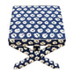 The Lee Industries X Ottoman features blue and white circular patterned upholstery and matching crossed legs, perfect for accent seating.