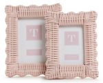 The Wicker Weave Scalloped Frame Collection in pink by Two's Company features two woven rattan frames with scalloped edges, each showcasing a placeholder image and highlighting skilled craftsmanship and rustic charm.