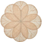 The Deborah Rhodes Sinamay Flower Placemat Collection Set features beige placemats crafted from woven abaca fibers, showcasing a petal-inspired pattern with overlapping leaf shapes accentuated by darker outlines.