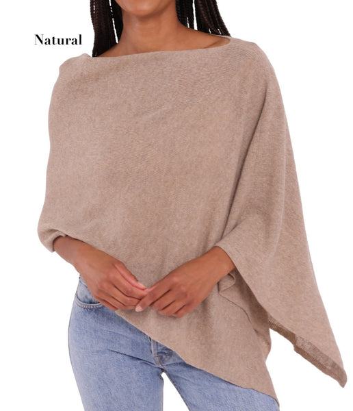 A woman stylishly transitions from day-to-night in an Alashan Cashmere Cashmere Dress Topper Poncho.