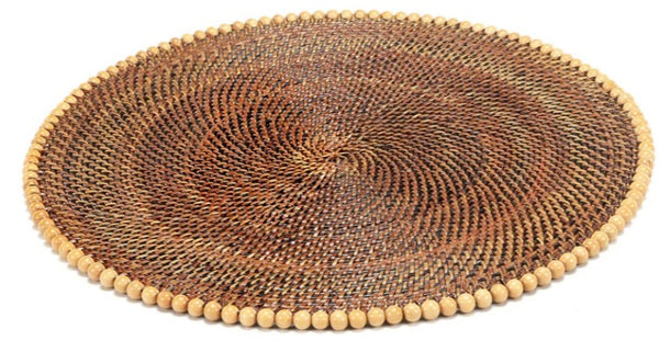 A Calaisio Round Placemat with Beads featuring a concentric pattern of brown and tan fibers, handmade by artisans using eco-friendly materials.