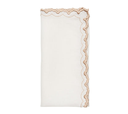 The Arches Napkin Set by Kim Seybert features folded white linen napkins with scalloped beige embroidered edges, perfect for formal dining and shown on a plain white background.