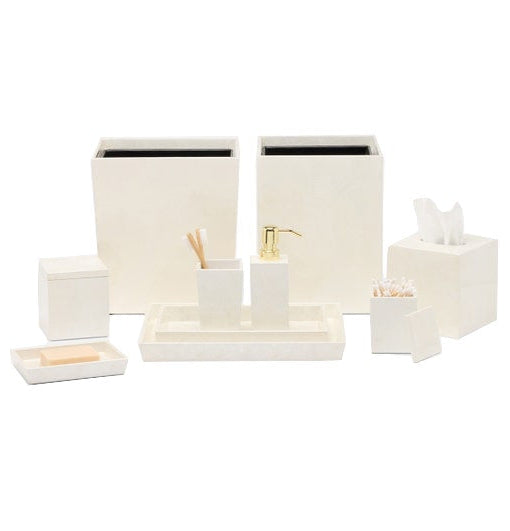 The Pigeon & Poodle Navagio Bath Collection set of off-white bathroom accessories, including a wastebasket, soap dispenser, tissue box cover, trays, and containers in spiraled burl resin.