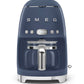 A blue Smeg Drip Filter Coffee Machine from the SMEG collection, boasting a 10-cup capacity, digital clock display, and chrome handle for a modern yet retro design.