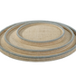 The Zodax La Côte Coiled Round Tray Collection features three nested round trays with light gray edges, stacked together against a white background—ideal for bringing coastal décor charm to your space.