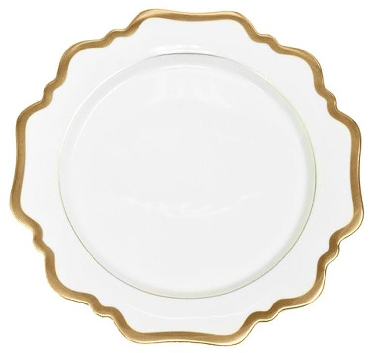 A white ceramic plate with a scalloped edge and gold trim from Anna Weatherley’s Anna’s Palette Antique White with Gold Dinnerware Collection, viewed from above on a plain background—reminiscent of the exquisite hand-painted pieces crafted in Budapest.