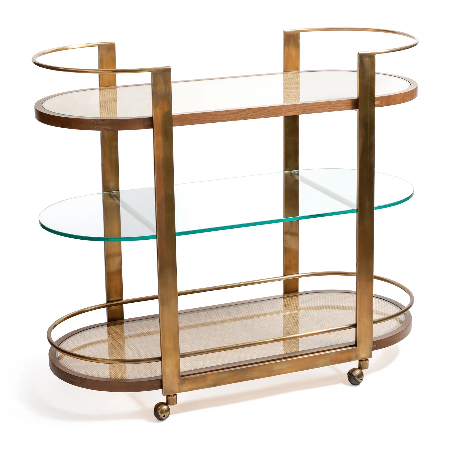 The Zodax Sloane Bar Cart features a brass frame, glass and mesh shelves, and four small wheels—an ideal addition for showcasing cocktail accessories in your home bar.