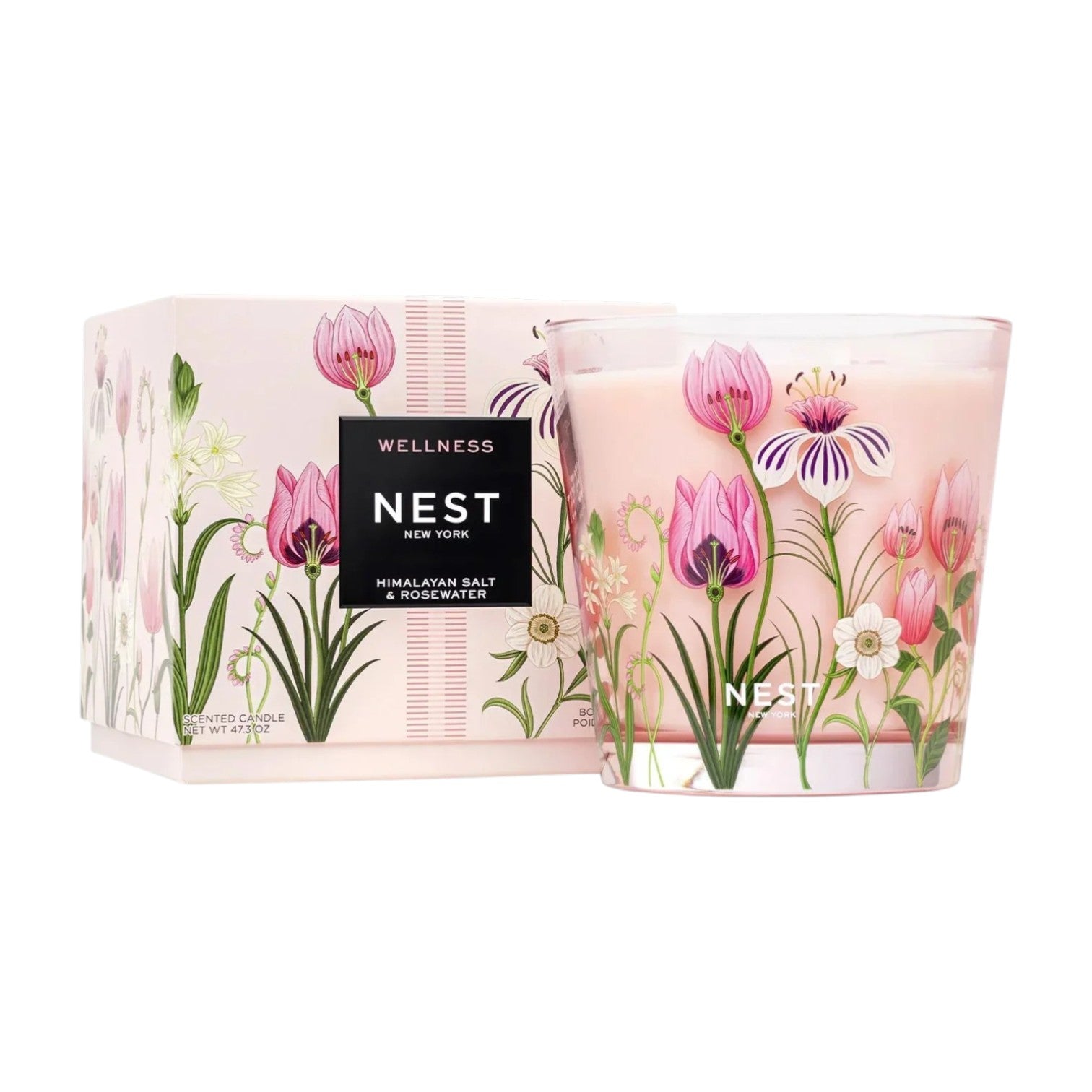 The Nest Himalayan Salt & Rosewater Candle Collection features candles with a long burn time, housed in floral packaging and matching glass containers decorated with pink and white flower designs.