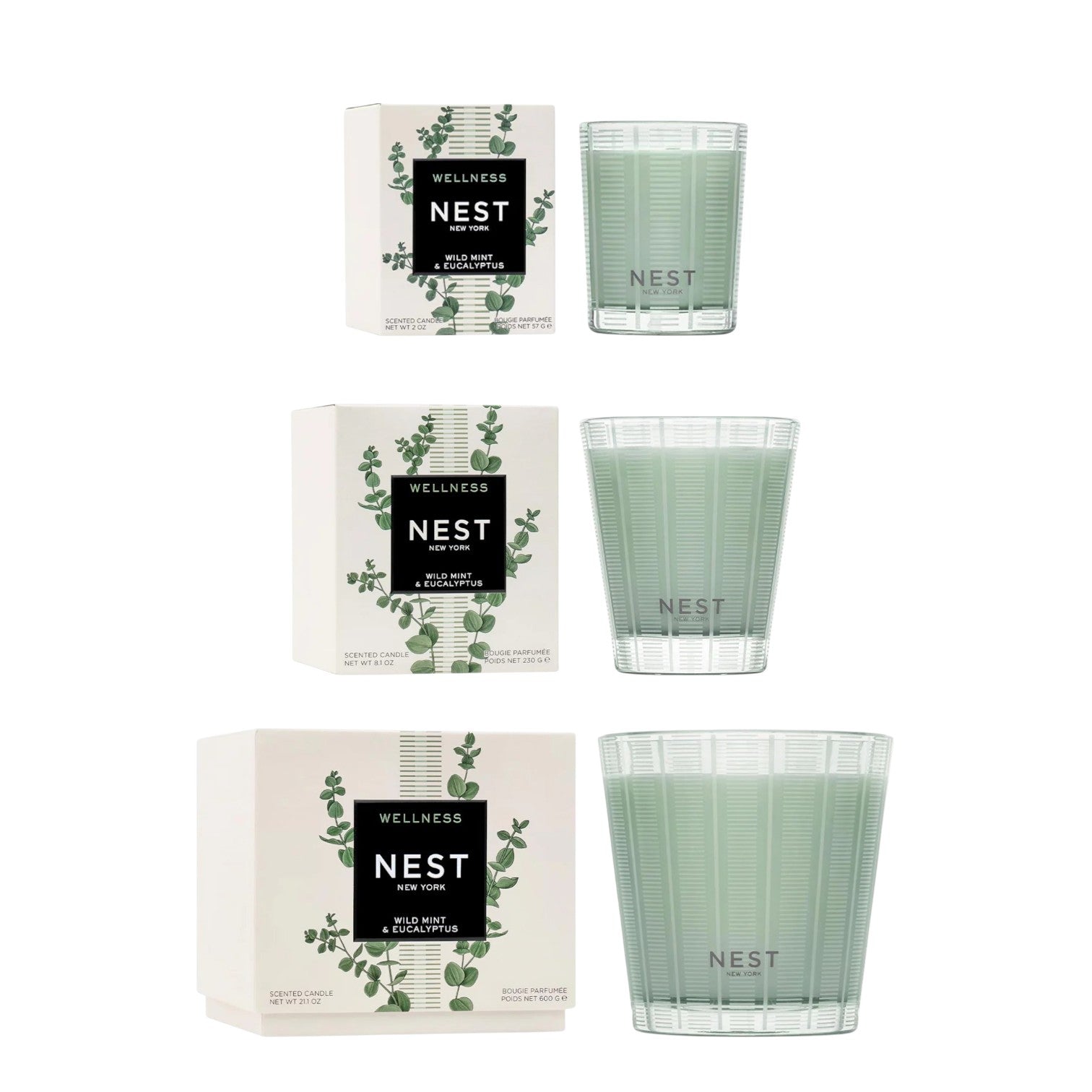 The Nest Wild Mint & Eucalyptus Candle Collection features three scented candles in green glass jars beside their boxes, all displayed vertically on a white background.