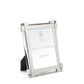 A glass-front Clear Classic Frame from William Yeoward Crystal features a bright nickel-plated finish, displays its label, and stands upright on a black easel back.