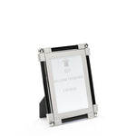 The Black Classic Frame Collection by William Yeoward Crystal features a rectangular nickel-plated metal and glass photo frame with black accents, standing upright. Its bright finish adds a modern touch, and the insert reads "William Yeoward Crystal.
