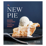 A slice of apple pie topped with melting vanilla ice cream rests on a black plate on the cover of The New Pie, a cookbook from Penguin Random House that highlights inventive pie recipes and creative baking techniques.