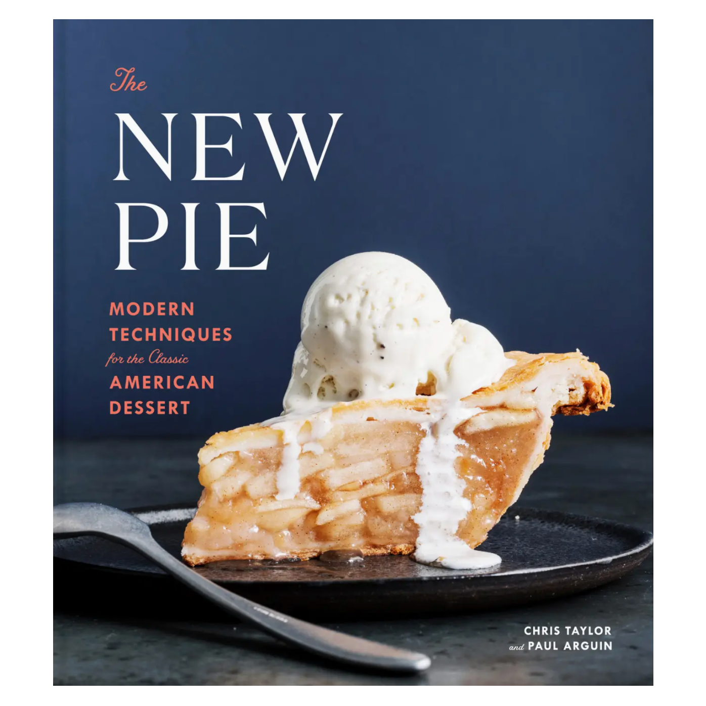 A slice of apple pie topped with melting vanilla ice cream rests on a black plate on the cover of The New Pie, a cookbook from Penguin Random House that highlights inventive pie recipes and creative baking techniques.