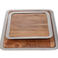 The Brasserie Steel and Acacia Wood Gastronomy Board Collection by Zodax features two stacking rectangular trays with metal rims and natural wood grain, ideal for use as charcuterie or gastronomy boards.