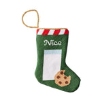 The Nice Needle Point Stocking by Bauble Stockings features a green body, red and white striped top, gold loop, and hand-stitched milk glass, cookie, and “Nice”—a festive heirloom for your holiday mantel.
