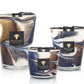 Three Baobab Collection Delta Nil candles with swirling blue and brown designs on a white background.