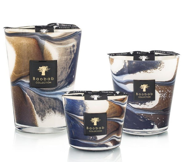 Three Baobab Collection Delta Nil candles with swirling blue and brown designs on a white background.