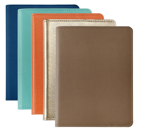 Four Graphic Image Leather Notebooks in blue, teal, gold, and brown are arranged fan-like on a white background. Each features spiral inserts and gold-gilded premium paper for luxurious and practical design.