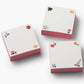 Three square sticky note pads from the Dahlia Collection by Riffle Paper Co., featuring pink sides and floral corner accents, arranged on a white background—a charming addition to your stationery.